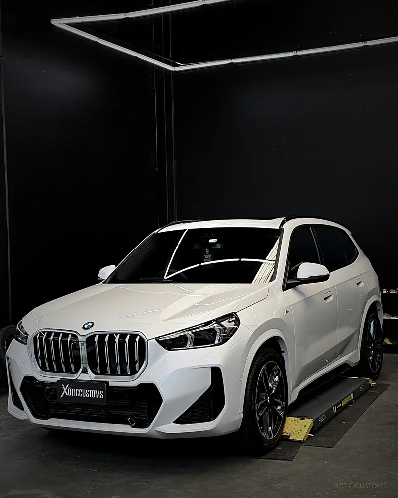 White BMW X1 with ceramic tint in the Xotic Customs studio