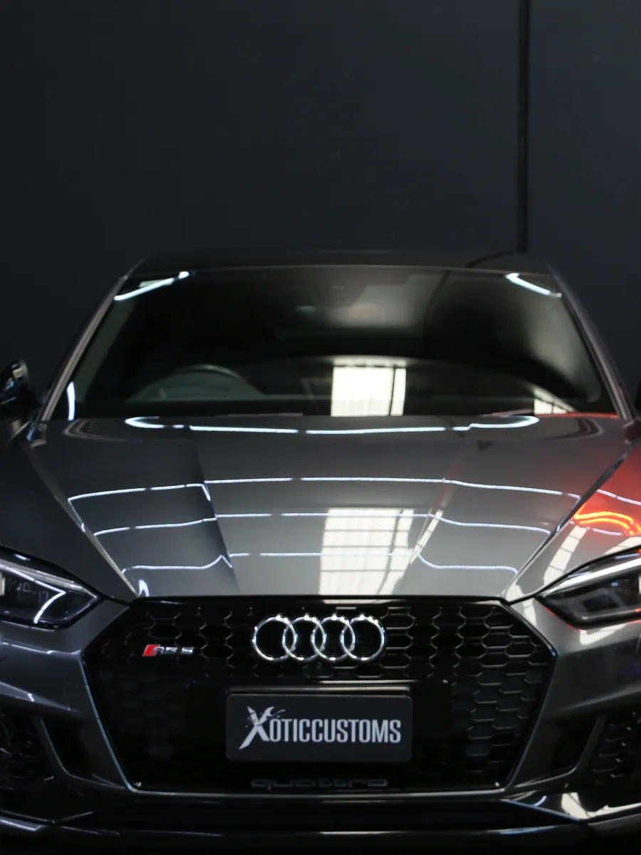 Grey Audi RS 5 Sportback under the lamps at Xotic Customs Melbourne